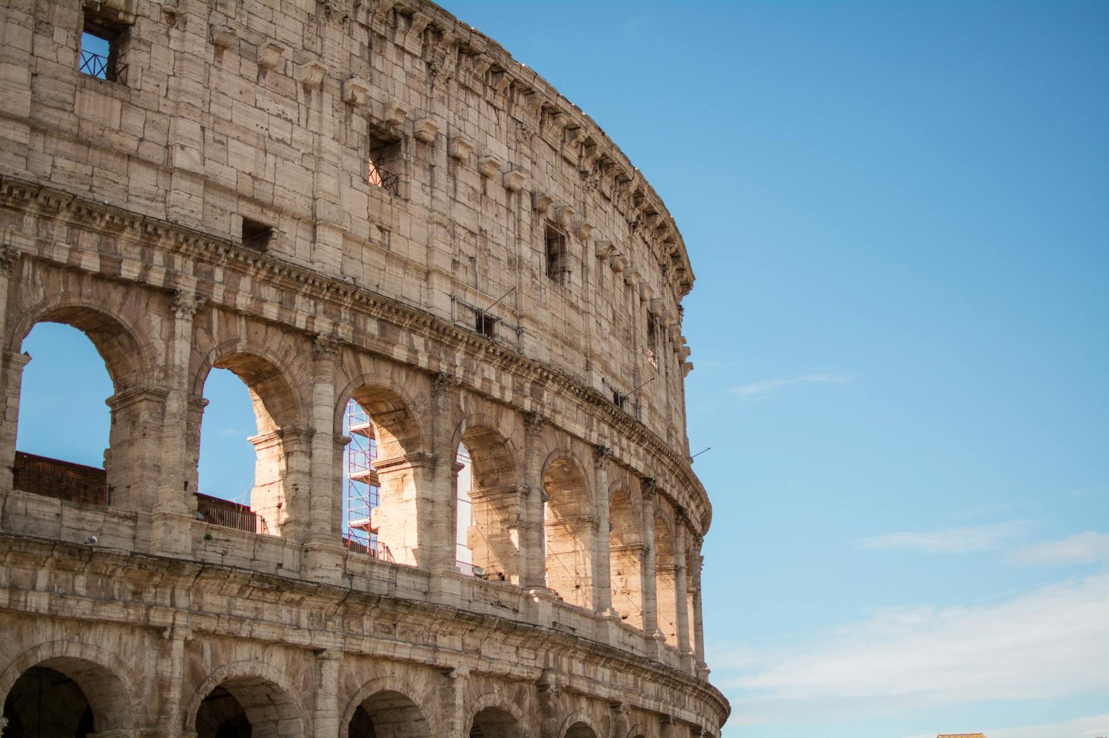 photo of coliseum under blue sky